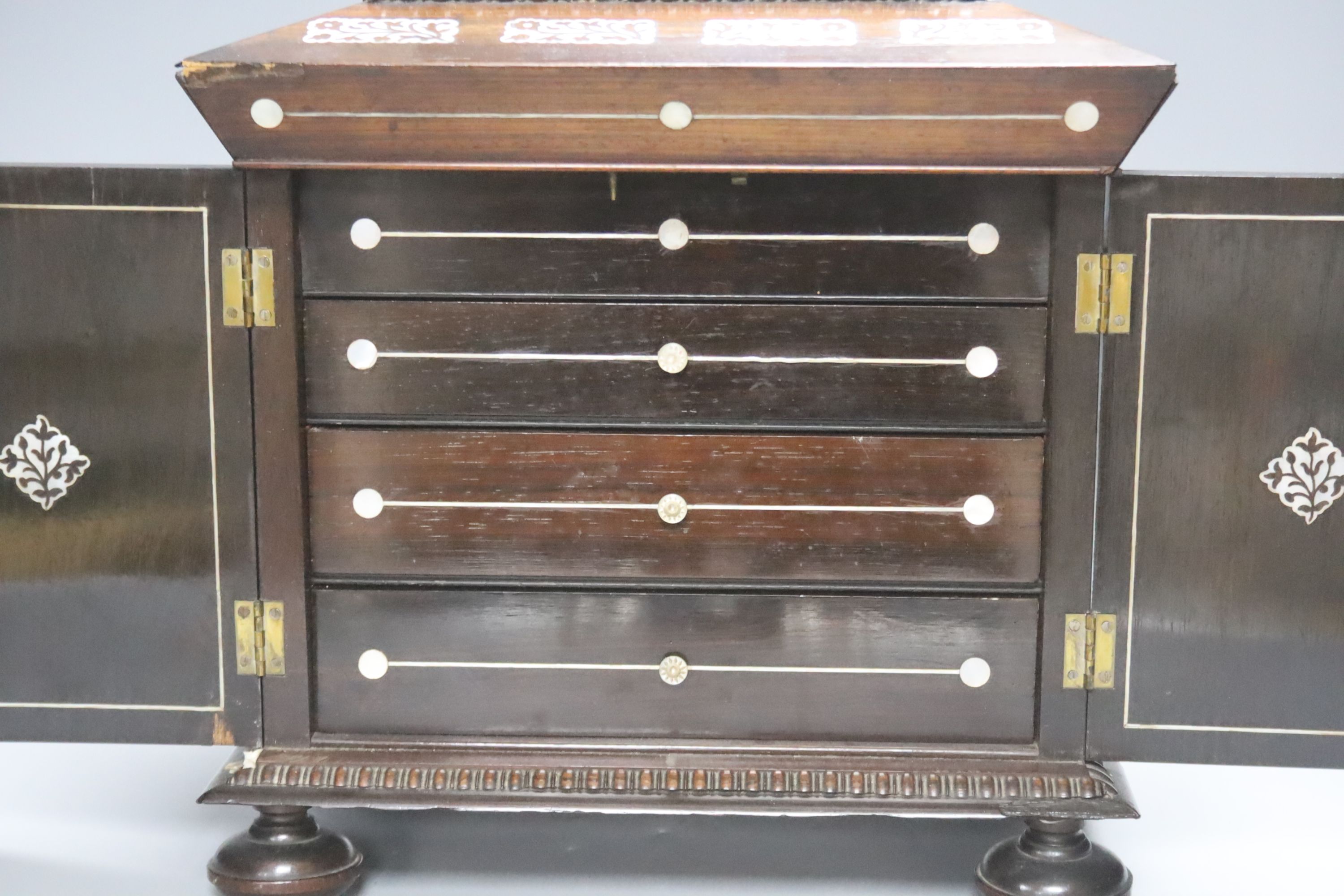 A William IV mother of pearl inset rosewood work box, height 36cm, containing mother-of-pearl and ivory items